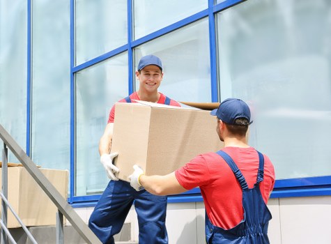 Piano moving team preparing an upright piano in a Mayfair property